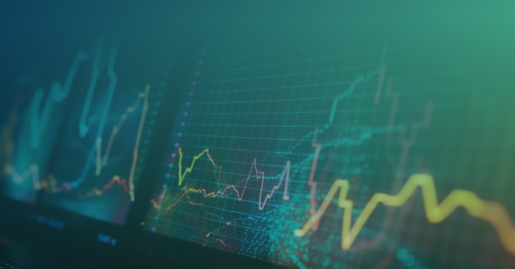 Abstract close-up of glowing multicolored line charts on a dark data-dashboard background, representing real-time analytics.