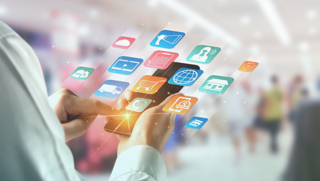 Photo of a person holding a smartphone surrounded by floating icons representing marketing, retail, delivery, payments, and communication channels, illustrating unified customer data activation.